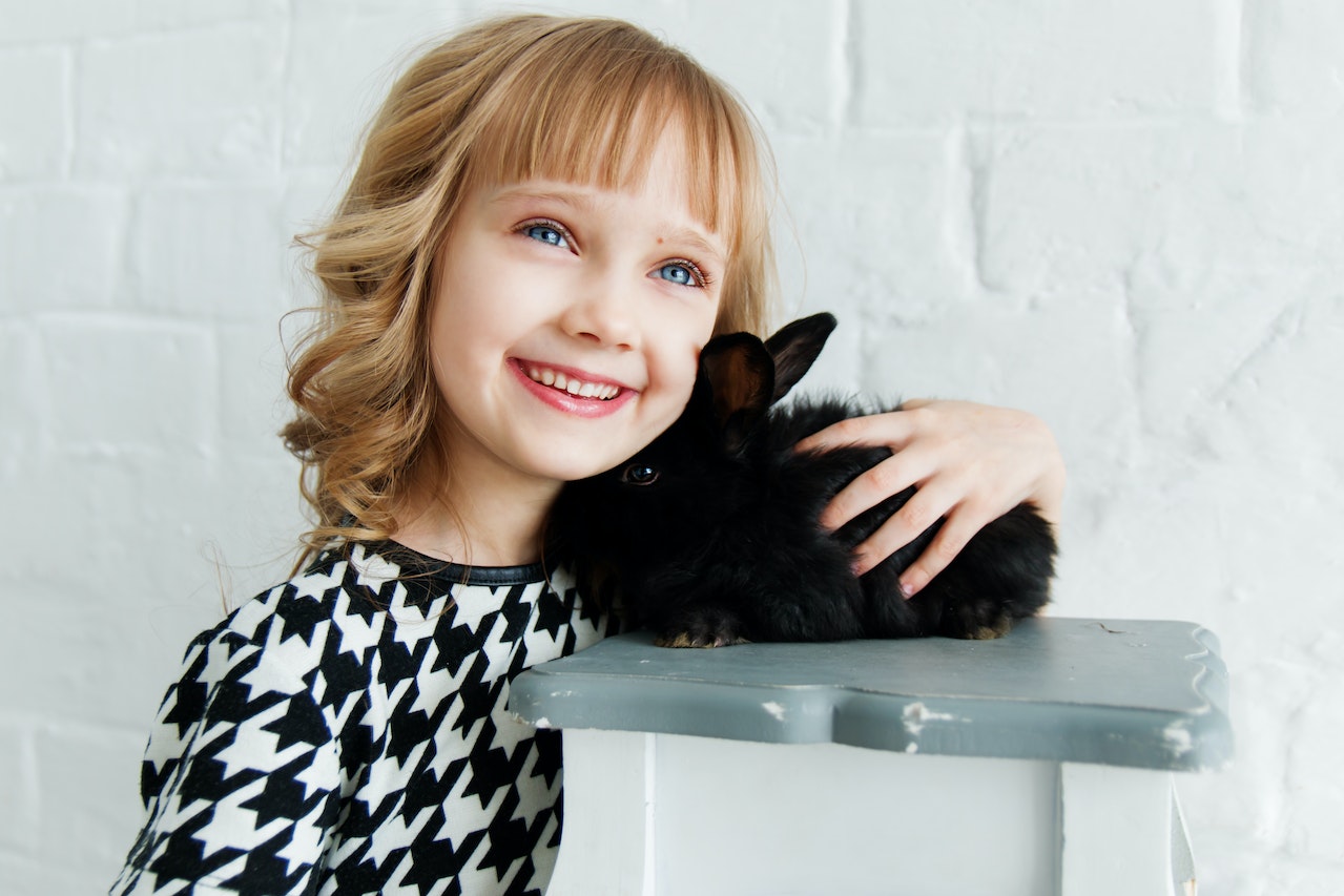 Exotic Pets for Children How to Choose the Right One and More, a little girl petting a rabbit